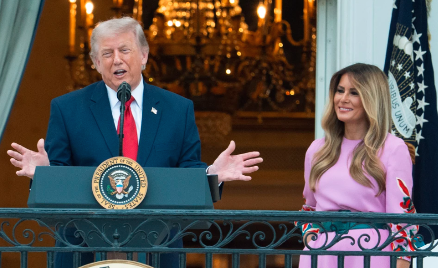 President Donald Trump with first lady Melania Trump addresses the attendees from the Blue Room Balcony of the White House during the annual Congressional Picnic on the South Lawn, Tuesday, May 19, 2026, in Washington. (AP Photo/Manuel Balce Ceneta)